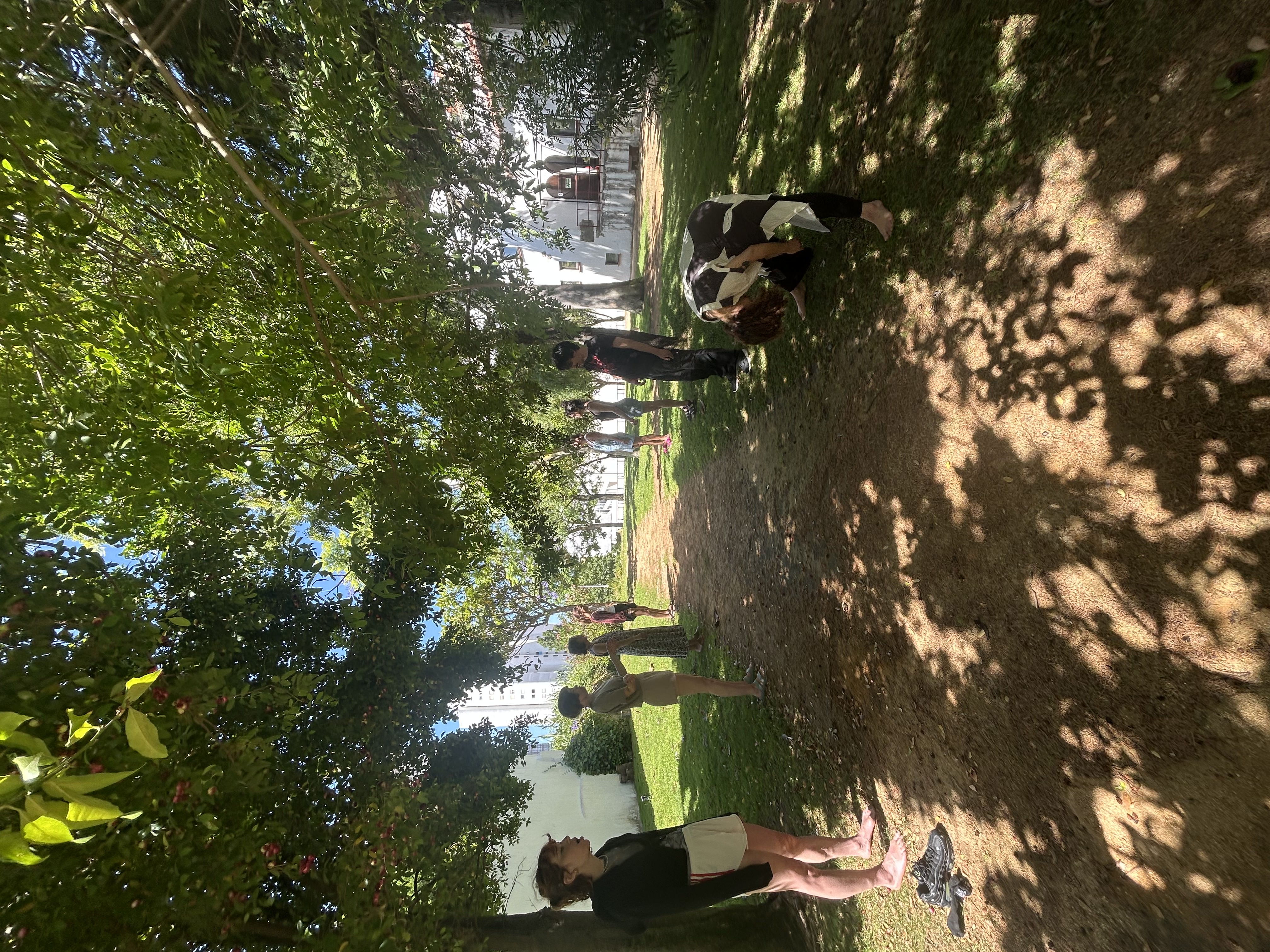 Participants gathered together outdoors under trees during an in-person Reset experience